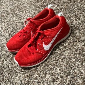 Red nike running/athletic shoes